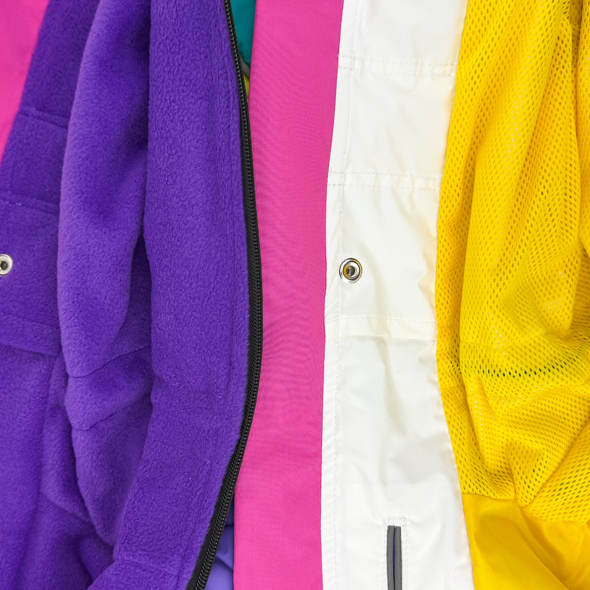 Close-up of the two linings side by side, purple fleece for winter and yellow mesh for autumn