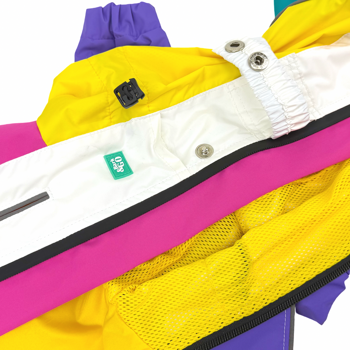 Close-up of the Bark&Go rubber label and metal snaps on the Rewind raincoat